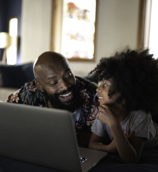 A father and child working on a laptop