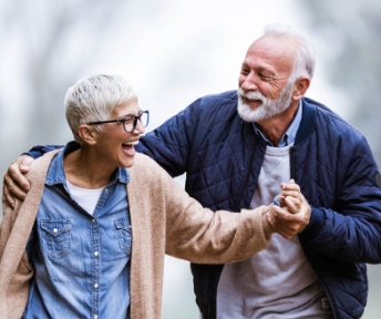 An older couple happily walking together