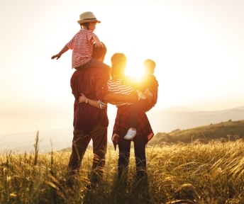 A happy family watching the sunset